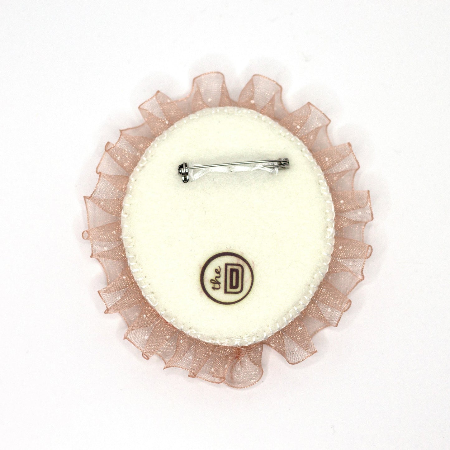 Back view of a handmade brooch featuring a popsicle and crystal beads on a white background showing pin fastener.