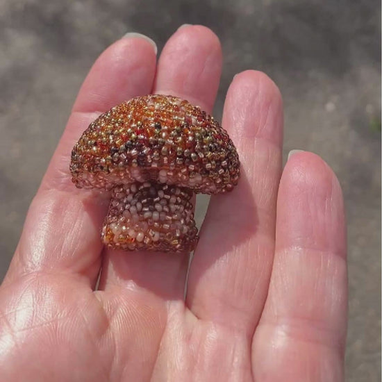 Video of a beaded brown mushroom brooch taken outside to show off the sparkle.
