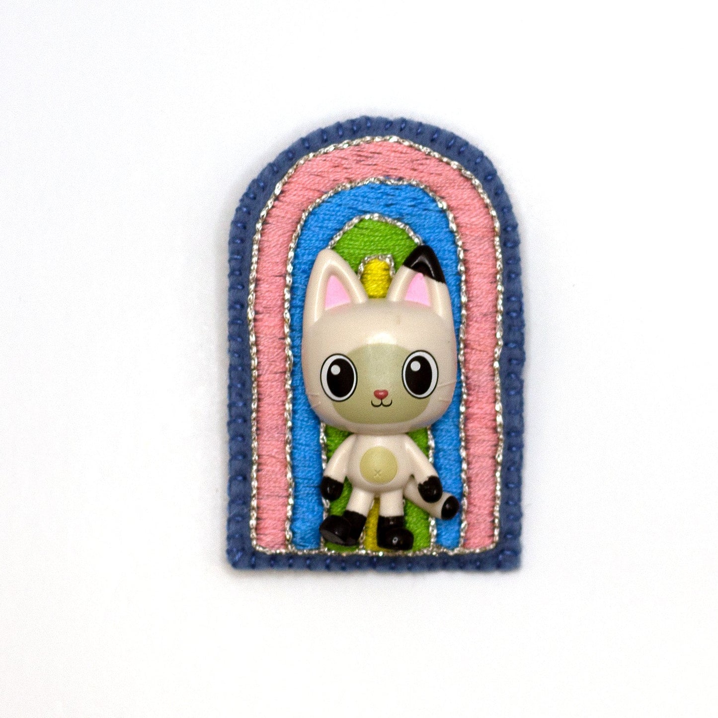 Handmade embroidered rainbow brooch featuring Pandy Paws shown on a white background.
