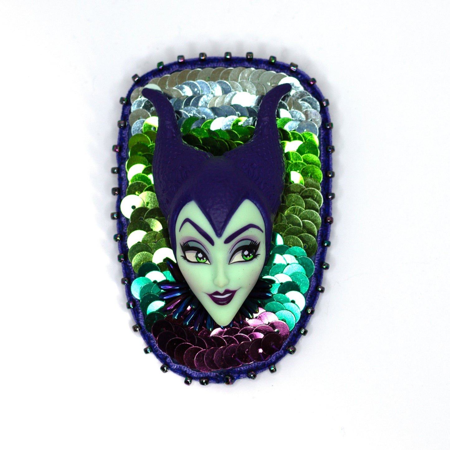 Handmade purple and green sequined brooch featuring a Maleficent doll shown on a white background.