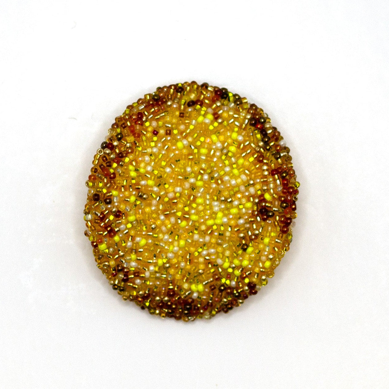 Handmade beaded golden yellow potato chip brooch shown on a white background.