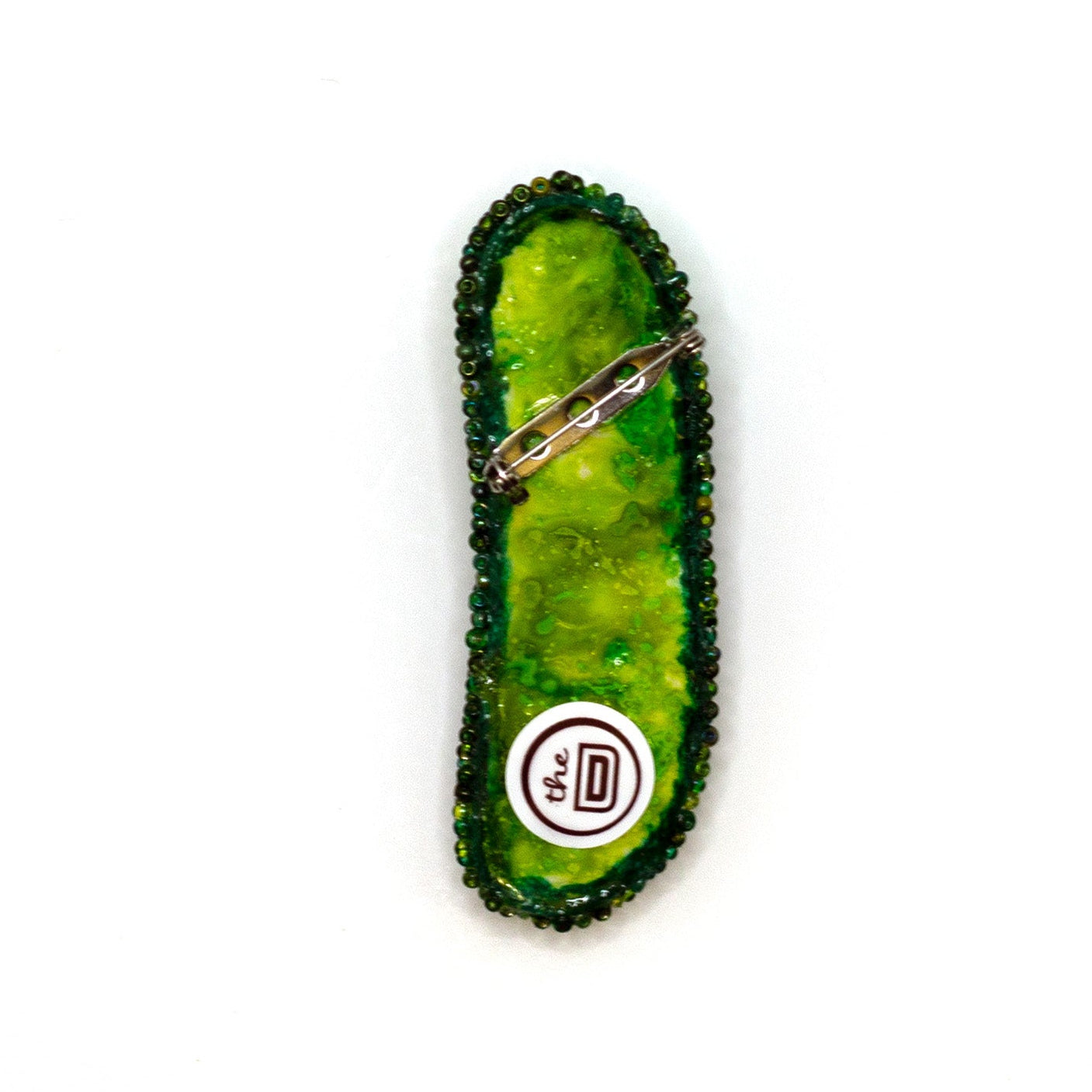 Handmade beaded pickle brooch on a white background showing pin fastener.