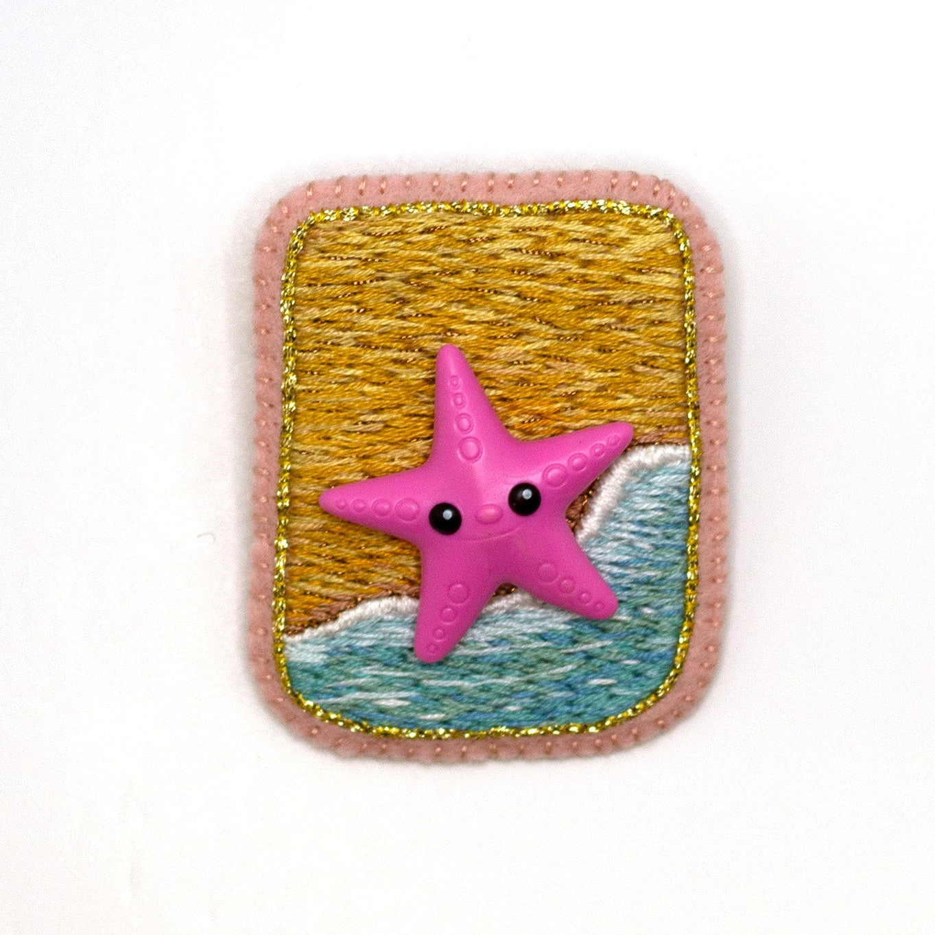 Handmade embroidered beach scene brooch featuring a starfish shown on a white background.